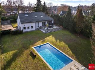 <p>Gelegen in het gegeerde Schilde-Bergen, uitstekend bereikbaar en met een oase van rust in eigen tuin.<br />Deze woning combineert het beste van twee werelden: dankzij de vlotte verbindingen, de nabijheid van vele scholen en het levendige dorpscentrum geniet u hier van een topligging met alle voorzieningen binnen handbereik.</p>
<p>De woning werd in 2021 grondig gerenoveerd, met vernieuwde technische installaties en maximale aandacht voor isolatie. Zonnepanelen en een warmtepomp dragen bij aan een energiezuinig en toekomstgericht wooncomfort.</p>
<p>Het volledig omheinde perceel is toegankelijk via een automatische poort en biedt ruime parkeermogelijkheden op eigen terrein.</p>
<p>Bij het binnenkomen leidt de inkomhal naar de ruime en lichtrijke leefruimte, bestaande uit een gezellige woonkamer, een eetruimte en een open leefkeuken. Grote raampartijen zorgen voor een mooie verbinding met de tuin en laten u in de zomer genieten van koken en tafelen met zicht op het zwembad, het luxueuze poolhouse én het ruime terras dat aan het huis is verbonden.</p>
<p>Op het gelijkvloers bevindt zich tevens een ruime master bedroom, aangevuld met een badkamer voorzien van inloopdouche.</p>
<p>Via enkele treden bereikt u de ruime kelder, ideaal als bergruimte. Daarnaast is er een grote inpandige garage met plaats voor twee wagens.</p>
<p>Op de eerste verdieping bevinden zich twee comfortabele slaapkamers en een doucheruimte met toilet.<br />De tweede verdieping beschikt over een volwaardige vierde slaapkamer, een badkamer met bad, douche en lavabo, én een extra polyvalente ruimte die perfect kan dienen als dressing, bureau, hobbyruimte of extra slaapkamer.</p>
<p>De tuin vormt een echte buitenbeleving. Aan het zwembad geniet u de hele dag van de zon, terwijl het poolhouse met overdekt terras en het aangelegde terras aan het huis zorgen voor instant vakantiesfeer, gewoon bij u thuis.</p>