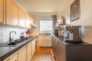 <p><strong>Geniet van zon en uitzicht op een centrale locatie.</strong> Dit lichtrijke appartement van 70 m² bevindt zich op de vijfde verdieping van een verzorgd gebouw met lift. Je woont hier rustig, met alle comfort en voorzieningen binnen handbereik.</p><p><br /></p><p><strong>Het appartement bestaat uit</strong> een woonkamer op parket met toegang tot een zonnig terras aan de voorzijde van het gebouw – een ingerichte keuken met ruimte voor een ontbijttafel – een hal (met ingemaakte kast) - een badkamer met ligbad en dubbele wastafel – een apart toilet – een berging - één slaapkamer – een terras achteraan met zicht op het mooie Runcvoortpark met vijver.</p><p><br /></p><p><strong>Troeven</strong>: twee terrassen, voor- en achteraan - automatische rolluiken in de slaapkamer - ondergrondse autostaanplaats (te huur aan 60 euro per maand)</p><p><br /></p><p>Bezoek mogelijk na aanmaken huurdersprofiel via https://mijnhuurprofiel.be/property/752a4fb4-5d50-4d4d-9462-a44dd04c1776</p>