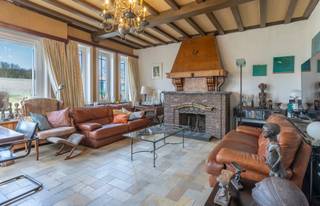 <p>Solid home with a stunning view.</p>
<p>This charming property is ideally located in an easily accessible yet rural setting in Itterbeek, Dilbeek.</p>
<p>The spacious entrance hall leads to the bright living room at the front of the house. Large windows flood the space with natural light, while the authentic open fireplace adds a warm and cosy atmosphere. At the rear, the spacious and fully equipped kitchen offers a magnificent view of the surroundings. Also on the ground floor, a generous bathroom with shower and vanity unit is available. The separate toilet is accessible from the enclosed terrace, which leads directly to the large garden (+/ 13 ares). On the first floor, three spacious bedrooms and a practical storage room are available, with ample built-in wardrobes throughout. A hatch provides access to an additional storage attic.</p>
<p>A major highlight of this home is the exceptionally large garage of approximately 65 m², fitted with an automatic door and adjoining cellar space, offering endless possibilities for storage, hobbies or use as a workshop. The driveway easily accommodates multiple vehicles.</p>
<p>Over the years, several improvements have been made, including the installation of a recent gas boiler, high-performance double glazing and a fully compliant electrical installation.</p>
<p>The property is centrally located with excellent access to Brussels, while enjoying the tranquility and greenery of its surrounding area.</p>