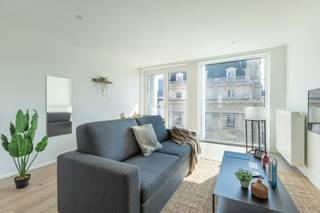 Located in the heart of Brussels, in the lively De Brouckère district and close to all amenities (transport, shops, restaurants, etc.), this beautiful furnished apartment of approximately 58 m² is on the 3d floor of a recently renovated building. It comprises a bright living room, a fully equipped open-plan kitchen, a comfortable bedroom, a modern shower room, a laundry room, a separate toilet and a pleasant balcony. The property is in excellent condition and offers all the necessary amenities: lift, double glazing, individual gas heating, water softener. Charges: Fixed fee of 195€ (communal, heating, hot water, WiFi and waiver of recourse insurance ). EPC: C+. Available on 01/11/2026. Measurements provided for information purposes only.