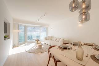 <strong>Smaakvol gerenoveerde appartement met zijdelings zeezicht</strong><br /><br />Indeling: Bij het binnenkomen word je verwelkomd in een inkomhal met een gastentoilet. De lichtrijke leefruimte sluit naadloos aan op het zonnige voorterras en biedt een mooi zicht op zee en het Lichttorenplein. De open keuken is volledig uitgerust en stijlvol afgewerkt.<br />Het appartement beschikt over twee volwaardige slaapkamers met ingemaakte kasten. Eén van de kamers biedt toegang tot een terras aan de achterkant. De moderne badkamer is voorzien van een ruime inloopdouche.<br /><br />Contacteer ons voor een bezoek!<br /><br />EPC: 66 kWh/m²/jaar - UC: 2869520-RES-1