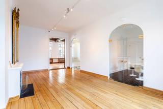 This exceptionally spacious duplex apartment occupies the first and second floors of a stately townhouse, offering a living area of approximately 315 m² complemented by a terrace of around 41 m².
An elevator in the communal entrance hall takes you directly into the apartment. Upon entering, you arrive in a beautiful hallway leading to the impressive, two-part living area—comprising a lounge and dining room—characterized by authentic wooden floors and exposed beams. A working fireplace creates a warm atmosphere. There is also a separate dining area, ideal for use as a breakfast room. The kitchen is fully equipped with appliances including an oven, microwave, induction cooktop, and dishwasher. Both the living area and the kitchen open onto the spacious, partially covered terrace. This floor also features a charming library with built-in cabinetry and a fireplace.
A staircase or elevator leads to the second floor, which houses the sleeping quarters. The master suite includes a spacious bedroom, a dressing room, and a bathroom equipped with a shower, bathtub, double vanity, toilet, and bidet. Additionally, there are two further full-sized bedrooms, a second bathroom with a shower and vanity, an extra dressing room, and a practical storage room.
Finally, a double parking space is included.
Private cellar and communal bicycle storage.
Communal charges: €100 per month.
Provision for water, heating, and electricity: €350 per month.
Available immediately.