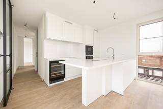 <p>Deze energiezuinige penthouse bevindt zich op de 3<sup>de</sup> verdieping van project “Teunishof” en is gelegen in het centrum van Sint-Antonius. Het appartement werd afgewerkt met hoogwaardige materialen en heeft een bewoonbare indeling van 110m² aangevuld met twee ruime terrassen.<br /><br />De inkomhal van 5m² is afgewerkt met steenparket en beschikt over ingebouwde vestiairekasten en een gastentoilet met handenwasser. Via een smeedijzeren deur met kathedraalglas bereikt u de lichtrijke woonkamer van 46m² met een stijlvolle ingebouwde kastenwand. De volledig ingerichte open keuken is voorzien van een composieten werkblad en kwalitatieve toestellen waaronder een wijnkoeler van Miele, een Quooker warmwaterkraan, een praktische koffiecorner en een gezellige ontbijthoek. Aansluitend bevindt zich de wasplaats van 4m² met uitgietbak.<br /><br />De hoofdslaapkamer van 9m² is afgewerkt met steenparket en grenst aan een dressing van 4m² eveneens op steenparket. De hoofdbadkamer van 6m² is uitgerust met een ligbad, lavabomeubel, linnenkast en toilet. Daarnaast is er een tweede slaapkamer van 15m² op steenparket en een tweede badkamer van 3m² met lavabomeubel en inloopdouche.<br /><br />Er bevinden zich vooraan en achteraan 2 mooie terrassen, van 17m² en 15m², waardoor u op elk moment van de dag kan genieten van zon.<br /><br />Het appartement beschikt bovendien over een grote bergkelder, alsook is er een mogelijkheid om 1 of 2 ondergrondse garageboxen met automatische poorten en extra bergruimte bij aan te kopen aan € 40.000, - per stuk exclusief 21% btw.<br /><br />BIJZONDERHEDEN<br />Extra troeven zijn de aanwezigheid van sunscreens, vijf zonnepanelen, blokdeuren, vloerverwarming, een geothermische warmtepomp voor zowel te verwarmen als te koelen, dubbele beglazing, aluminium schrijnwerk, een veiligheidsdeur, videofoon, dimmers, lift, speaker aansluitingen, alsook aansluiting voor een laadpaal.<br /><br />POSITIEVE PUNTEN<br />EPC label A<br />2 ruime terrassen<br />Onderhoudsvriendelijk<br />Hoogwaardig afgewerkt<br />Zéér goede bereikbaarheid<br />Voorzien van alle moderne technieken<br />Gelegen in het centrum van Sint-Antonius</p>