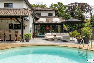 <p><span>Droomt u van het Zuiden? Ontdek deze prachtige Provençaalse villa met royale living en idyllische tuin!</span></p><p><span> </span></p><p><span>Welkom in deze unieke karaktervolle villa, gelegen op een ruim perceel van 900 m², waar comfort, stijl en privacy samenkomen. Vanaf het moment dat u binnenstapt in de sfeervolle inkomhal met Bourgondische tegels, voelt u het karakter en de klasse van deze woning.</span></p><p><span> </span></p><p><span>Gelijkvloers:</span></p><p><span>De indrukwekkende living van maar liefst 75 m², met authentiek plafond, biedt een zee van ruimte en licht. De woonkamer (53 m²) is ideaal georiënteerd op het oosten, zuiden én westen, waardoor u de hele dag door geniet van zon en uitzicht op de prachtig aangelegde tuin. Werken of studeren doet u in alle rust in de bureelruimte (7 m²), terwijl de gezellige, gesloten veranda (15 m²) met ingebouwde spots perfect is voor sfeervolle avonden of een ontspannen ontbijt.</span></p><p><span> </span></p><p><span>Keuken:</span></p><p><span>De volledig ingerichte lichte, moderne keuken met hedendaagse elementen is een waar paradijs voor kookliefhebbers, voorzien van alle moderne apparatuur en schitterend fornuis van SMEG. </span></p><p><span>Praktisch comfort vindt u in de aparte wasplaats, berging en de ruime garage met automatische poort en werkhoek. Voor gasten of extra auto's zijn er maar liefst drie autostaanplaatsen voor de woning.</span></p><p><span> </span></p><p><span>Buiten geniet u van het leven op het royale, gesloten terras (19 m²) met bar en tv of op het open terras (30 m²). De schitterende, volledig omheinde tuin met chalet biedt privacy en is een oase van rust en groen.</span></p><p><span>In het nieuw aangelegde zwembad met terras kunt u genieten van een heerlijk verkoelende duik op warme zomerdagen. In het chalet kunt u zicht naar hartenlust uitleven in een gym voorzien van de nodige apparaten.</span></p><p><span> </span></p><p><span>Verdieping:</span></p><p><span>Op de verdieping bevinden zich drie ruime slaapkamers op parket, waaronder een master bedroom van 27,5 m². </span></p><p><span>De badkamer is uitgerust met dubbele lavabo, relaxbad, aparte massagedouche en toilet welke opgefrist dient te worden. </span></p><p><span> </span></p><p><span>Uw veiligheid is verzekerd dankzij het elektronische beveiligingssysteem en de stijlvolle poort met camerabewaking en elektrisch slot.</span></p><p><span>De woning is voorzien van verwarmingsinstallatie en airco met warmtepomp en zonnepanelen.</span></p><p><span>Het is een energiezuinige woning met een EPC B en asbestvrij.</span></p><p><span> </span></p><p><span>Kortom: deze villa biedt alles voor wie op zoek is naar ruimte, comfort, privacy en een vleugje Zuid-Franse charme. Maak snel een afspraak en laat u verrassen door deze unieke woning!</span></p><p><span> </span></p><p><span> </span></p>