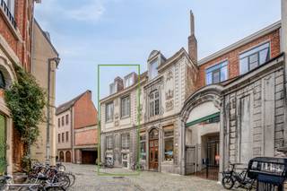 <h3>Uniek pand met atelier en woongelegenheid in hartje Leuven</h3>
<p>In het hart van Leuven, in de charmante Schrijnmakersstraat (“Schrènsstroot”), vlak naast de keuken van Dagelijkse Kost en om de hoek van de Mechelsestraat, bevindt zich dit ruime pand met een totale oppervlakte van ca. <strong>366 m²</strong>.</p>
<p>Achter de authentieke gevel bevindt zich op het gelijkvloers een ruime <strong>atelier-/handelsruimte van ca. 172 m²</strong>, voorzien van sanitair, aansluitingen voor een keuken, een aangename koer en toegang tot een kelder, ideaal als extra stockage. <strong>Het atelier is verhuurd tot 24/06/2029.</strong></p>
<p>De verdiepingen zijn momenteel ingericht als twee afzonderlijke woonunits, met oppervlaktes van ca. 88 m² en 106 m². Eén van de woonunits beschikt bovendien over een balkon.</p>
<p><strong>De stedenbouwkundig vergund geachte toestand </strong>omvat een atelier op het gelijkvloers en één zelfstandige woongelegenheid. De huidige indeling van de verdiepingen biedt, mede dankzij de ruime oppervlaktes, <strong>verschillende mogelijkheden voor de toekomstige eigenaar</strong>. Zo kan onder meer het <strong>kotmadamprincipe</strong> interessante mogelijkheden bieden. De concrete mogelijkheden dienen uiteraard verder te worden bekeken in functie van de geldende stedenbouwkundige voorschriften.</p>
<p>Het pand beschikt over een absolute topligging, op wandelafstand van de Grote Markt, de Mechelsestraat, winkels, horeca en alle voorzieningen die Leuven te bieden heeft.</p>
<p>Een bijzonder pand met <strong>veel ruimte, karakter en potentieel</strong>, ideaal voor wie op zoek is naar een combinatie van wonen en werken, een ruime stadswoning of een interessante eigendom op een toplocatie.</p>
<p>Interesse? Contacteer <strong>Anne-Leen op 0495 13 81 11</strong> voor meer informatie of een bezoek.</p>