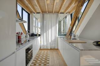 Op de derde verdieping van een kleinschalig gebouw in de Pachtstraat bevindt zich dit bijzondere dakappartement. Het appartement werd gerenoveerd in 2016 en combineert authentieke elementen met een hedendaagse afwerking. Het prachtige houten dakgebinte, de vele glaspartijen en de open leefruimte geven het appartement een uitstraling die je niet snel ergens anders vindt.<br /><br />De lichtrijke leefruimte vormt het hart van het appartement. De zichtbare houten balken en hoge dakstructuur zorgen voor karakter, terwijl de verschillende dakramen en grote raampartijen voor veel natuurlijk licht zorgen. De open keuken sluit naadloos aan op de leef- en eetruimte en werd strak en tijdloos ingericht.<br /><br />Een absolute troef is het ruime zonnige terras.<br /><br />De slaapkamer beschikt over een eigen badkamer met inloopdouche, lavabo en toilet. Ook hier zorgen het schuine dak, de witgeschilderde bakstenen muur en het dakraam voor de typische charme van het appartement.<br /><br />Indeling<br /><br />- lichtrijke leef- en eetruimte<br />- open ingerichte keuken<br />- één slaapkamer<br />- badkamer met inloopdouche, lavabo en toilet<br />- ruim terras<br /><br />Troeven<br />- toplocatie in 2000 Antwerpen<br />- volledig gerenoveerd in 2016<br />- EPC B<br />- ruim en aangenaam terras<br />- karaktervol houten dakgebinte<br />- veel natuurlijke lichtinval<br />- kleinschalig gebouw<br />- weinig gemeenschappelijke kosten<br /><br />Ook de ligging in Antwerpen is een belangrijke troef. De Pachtstraat ligt op een fijne locatie van waaruit zowel het historische centrum als winkels, horeca en openbaar vervoer vlot bereikbaar zijn. Je geniet hier van het stadsleven van Antwerpen, terwijl het appartement zelf dankzij zijn ligging op de bovenste verdieping een aangenaam gevoel van rust en privacy biedt.<br /><br />Dit dakappartement te koop in Antwerpen is dan ook een mooie opportuniteit voor wie geen klassiek appartement zoekt, maar vastgoed met een eigen identiteit, een sterke locatie en een fijne buitenruimte.<br /><br />Op zoek naar een karaktervol appartement om te kopen in Antwerpen? Contacteer ons voor meer informatie of een bezoek aan dit unieke appartement te koop in Antwerpen.<br /><br />Had u graag uw eigen eigendom te koop aangeboden? Contacteer ons dan voor een vrijblijvende schatting. Ook voor alle andere vragen omtrent immo, kopen of verkopen in Antwerpen kan u steeds bij ons terecht.<br /><br />Bestuursmaatregelen in het maatregelenregister: nee