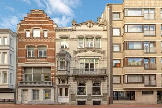 This authentic mansion from the early 20th century (1907) is located in the belle-époque district of Blankenberge, just 150 meters from the promenade, sea, and beach. You live here in a quiet part of the city, with shops, restaurants, and public transport nearby, and with the nature of dunes and polders within walking distance.<br /><br />The property in art nouveau style exudes character and elegance thanks to its stately façade, high ceilings, and spacious layout. The authenticity has been carefully preserved. The ground floor includes a spacious entrance hall, multiple living spaces (living room, dining room, family room), and a kitchen with access to a cozy patio terrace.<br /><br />On the upper floors, there are 7 bedrooms and various living spaces: three bedrooms and two bathrooms on the first floor, two bedrooms and an additional living space on the second, and two more bedrooms with a bathroom on the third floor. Above that is a spacious attic storage. A basement with plenty of storage completes the property.<br /><br />This unique mansion is ideal for those seeking space, authenticity, and a prime location on the Belgian coast, perfect as a family home, second residence, or B&amp;B.<br /><br />Advantages:<br />- authentic mansion (1907)<br />- art nouveau style<br />- 7 bedrooms<br />- patio terrace<br />- spacious basement<br />- belle-époque district<br />- only 150 m from the sea and promenade.<br /><br />3D tour at www.hillewaere-vastgoed.be