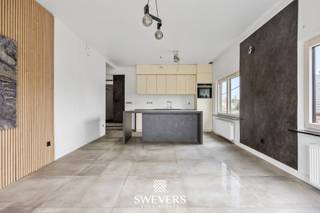 Voor meer info en foto’s, surf naar www.swevers.be – Dit ruime en instapklare appartement op de eerste verdieping in de Larenstraat 67 in Lummen werd oorspronkelijk gebouwd in 1976 en kreeg in 2022 een grondige renovatie. Met een bewoonbare oppervlakte van 123 m² en gelegen op een perceel van 14a 25ca geniet u hier van een hedendaagse afwerking, veel lichtinval en een praktische indeling. De centrale inkomhal leidt naar de lichtrijke leefruimte van 33,6 m², waar u vlot een gezellige zithoek en eethoek kan inrichten. Aansluitend bevindt zich de functionele keuken van 10 m², die mooi aansluit op het leefgedeelte. Het appartement beschikt over maar liefst 4 volwaardige slaapkamers van 11,5 m², 11 m², 11 m² en 23 m². De grootste kamer biedt extra mogelijkheden als master bedroom met dressing of bureau. In alle slaapkamers ligt parket, wat zorgt voor een warme uitstraling. De badkamer is uitgerust met een douche en er is een apart toilet aanwezig. Extra troeven zijn de privatieve garage van 20 m², de ruime gemeenschappelijke tuin van 876 m² met noordelijke oriëntatie en de aanwezigheid van 24 zonnepanelen. Ook de ligging is bijzonder praktisch, met scholen en ontspanning op 500 meter, een bushalte op 190 meter, winkels en restaurants binnen 2 km en de snelweg op slechts 2,5 km. Een ruim en verzorgd appartement met hedendaags comfort, veel mogelijkheden en een vlotte bereikbaarheid. Voor meer informatie, bel 012 699 900. Bron bewoonbare oppervlakte: EPC – verslag.