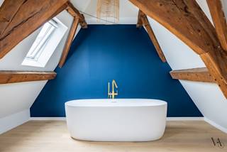 Op een centrale locatie in het historische stadscentrum van Leuven bevindt zich deze charmante rijwoning, waar authentieke elementen en een hedendaagse afwerking mooi samenkomen.<br /><br />De woning werd met veel zorg gerenoveerd en valt meteen op door haar warme houten accenten, karaktervolle balken en lichte, sfeervolle ruimtes. Op de eerste verdieping bevindt zich de gezellige leefruimte met aansluitend de open en volledig geïnstalleerde keuken.<br /><br />Verspreid over de verschillende verdiepingen zijn er drie slaapkamers en vier badkamers, waardoor de woning zich uitstekend leent voor zowel (nieuw samengestelde) gezinnen als co-housers. Een absolute blikvanger is de ruimte onder het dak, waar de authentieke houten dakstructuur volledig tot haar recht komt en het vrijstaande bad voor een unieke, sfeervolle uitstraling zorgt.<br /><br />Ook buiten heeft deze stadswoning een mooie troef: het ruime, zuidgerichte dakterras is een heerlijke plek om in alle rust van de zon te genieten, midden in de stad.<br /><br />De huurprijs bedraagt € 1.950 per maand. Er zijn geen gemeenschappelijke kosten en de nutsvoorzieningen zijn individueel ten laste van de huurder. De woning is beschikbaar vanaf 1 januari 2027 en wordt verhuurd met een huurcontract van korte duur.<br /><br />Een karaktervolle stadswoning met verrassend veel ruimte, een verzorgde afwerking en een heerlijk terras in hartje Leuven. Contacteer ons gerust voor meer informatie of een bezoek ter plaatse.