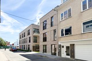 Dit gloednieuwe en instapklare duplexappartement maakt deel uit van residentie Thuis aan de Statie, een energiezuinig nieuwbouwproject in de stationsbuurt van Deinze. Dankzij de centrale ligging bevinden winkels, scholen, restaurants, sportfaciliteiten en het station zich op wandelafstand. Ook de E17 is vlot bereikbaar, wat zorgt voor een uitstekende verbinding richting Gent en Kortrijk. Met een bewoonbare oppervlakte van 170,90 m², een zuidgericht terras van 11,2 m² en een indrukwekkende plafondhoogte van meer dan 4 meter in de leefruimte biedt dit appartement een uitzonderlijk gevoel van ruimte en licht. Daarnaast genieten bewoners van een gemeenschappelijke daktuin van 300 m² met een prachtig uitzicht over Deinze.<br /><br />Via de inkomhal op de bovenste verdieping betreedt u het appartement. Hier bevindt zich de lichtrijke leefruimte met open keuken, waar de royale plafondhoogte van meer dan 4 meter en de grote raampartijen zorgen voor een aangename woonbeleving. Aansluitend vindt u een praktische berging, een afzonderlijk toilet en toegang tot het zuidgericht terras van 11,2 m².<br /><br />Een verdieping lager, die te bereiken is met de trap én met de lift, bevindt zich het nachtgedeelte. Hier beschikt het appartement over drie volwaardige slaapkamers, een afzonderlijk toilet en twee badkamers, beide uitgerust met een dubbele wastafel en een inloopdouche. Dankzij deze doordachte indeling worden wonen en slapen optimaal van elkaar gescheiden.<br /><br />Dit appartement werd uitgerust met duurzame en toekomstgerichte technieken. Zo beschikt het over een individuele warmtepomp in combinatie met vloerverwarming, wat zorgt voor een optimaal comfort en een laag energieverbruik. Daarnaast is een ventilatiesysteem type D met warmterecuperatie voorzien en wordt het sanitair warm water aangemaakt via de geïntegreerde boiler van de warmtepomp. De kwalitatieve afwerking omvat een moderne keuken met inbouwtoestellen, stijlvolle badkamers met betegelde inloopdouches en hoogwaardige vloerafwerking.<br /><br />Indien gewenst kan er een bovengrondse afgesloten autostaanplaats aangekocht worden voor de prijs van 22.000 euro. <br /><br />E-peil: E30 / EK confom<br /><br />Verlaagd btw-tarief van 6% mogelijk op de volledige constructiewaarde, nu ook voor investeerders mits min. 15 jaar verhuur.<br /><br />Benieuwd naar dit unieke appartement? Een persoonlijke, vrijblijvende afspraak kan via guillian@landbergh.be of 09 278 78 79.