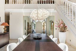 This beautiful villa with an "open space" concept in Kapellen is a dream home for anyone looking for luxury and comfort.<br /><br />Built in 2002, the property is located on a spacious plot of 2060 square meters and has a living area of 297 square meters.<br />We drive through the automatic gate onto the property and easily park our car in the designated parking spaces or in the double garage.<br /><br />Upon entering the villa, we are bathed in light thanks to the surprising "open space" concept, which is very characteristic of this exceptional villa.<br /><br />From the entrance hall, we have a connection to the living and dining area and a beautiful connection to the garden.<br /><br />We take the glass door to the living area and notice the unfolding high open void, creating a very spacious feeling.<br />The living area with fireplace seamlessly flows into the living-dining kitchen.<br />This is equipped with the necessary appliances, a kitchen island, and a breakfast nook with a view of the garden.<br />A utility room/laundry room and a double garage provide the necessary living comfort in the home.<br /><br />Furthermore, there is a master bedroom on this ground floor with a built-in wardrobe and an en-suite full bathroom with shower, bath, and sink with cabinets.<br /><br />We take the open staircase from the living room to the first floor.<br /><br />The landing connects the four bedrooms and the open office space with a view of the garden.<br /><br />There is a separate bathroom on the landing and a bathroom that is en-suite to one of the 4 bedrooms.<br /><br />Outside, there is a beautifully landscaped garden with a sunny southwest-facing terrace, where you can enjoy the sun.<br /><br />In addition, there is a spacious garage with space for 2 cars and ample parking on the property.<br /><br />In short, this villa in Kapellen is an ideal place to live for those seeking comfort, luxury, and space.<br />With all the amenities you need and a beautiful environment, this is a dream home that meets all your desires.<br /><br />Extraordinary features<br />- quiet environment<br />- 5 bedrooms: master/guest room on the ground floor and 4 bedrooms on the first floor<br />- all comfort<br />- well-maintained<br />- accessibility to public transport, shops, schools<br />- ready to move in<br /><br />EPC = 197 kWh/m² - Vg - Wg - Gmo - Gvkr - Gvv