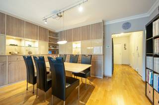 <p><span>Dit verzorgd appartement op de eerste verdieping met garage biedt een aangename indeling, praktische voorzieningen.</span></p><p><span>Keuken</span><span><br />De keuken is uitgerust met een </span><span>stenen vloer</span><span> en kwalitatieve toestellen, waaronder een </span><span>Siemens-kookplaat</span><span>, </span><span>Miele-vaatwasser</span><span>, </span><span>heteluchtoven</span><span> en </span><span>combi-microgolf van Neff</span><span>, en een </span><span>koelkast met twee vriesvakken</span><span>.<br />Een functionele en volledig uitgeruste ruimte voor wie graag kookt.</span></p><p><span>Leefruimte</span><span><br />Aansluitend bevindt zich de </span><span>lichte leefruimte op parketvloer</span><span>,</span><span> voorzien van een </span><span>ingemaakte kast</span><span>.<br />Dankzij het grote raam geniet je van aangename lichtinval en toegang tot het </span><span>terras vooraan</span><span>.<br />De aluminium ramen beschikken over </span><span>dubbele beglazing</span><span> en een </span><span>zonnescreen</span><span>, bedienbaar via afstandsbediening én app.</span></p><p><span>Inkom &amp; praktische ruimtes</span><span><br />De inkomhal is uitgerust met een </span><span>parlofoon</span><span> en </span><span>vestiairekast</span><span>.</span><span><br />Er is een </span><span>apart toilet</span><span> met handenwasser.<br />Een handige </span><span>berging</span><span> biedt plaats aan de CV-installatie </span></p><p><span>Slaapkamers</span></p><ul><li><span>Slaapkamer 1</span><span> beschikt over ingemaakte kasten en ramen met </span><span>vliegenhor</span><span>.</span></li><li><span>Slaapkamer 2</span><span> heeft eveneens een ingemaakte kast, een schuifraam naar het </span><span>achteraan gelegen vernieuwde terras</span><span> én extra opbergruimte buiten.</span></li></ul><p><span>Badkamer</span><span><br />De badkamer is stijlvol afgewerkt met </span><span>parkettegels</span><span> en voorzien van een </span><span>regendouche met handdouche</span><span>, </span><span>lavabomeubel met spiegelkast</span><span> en een </span><span>handdoekwarmer</span><span>.</span></p><p><span>Wasplaats</span><span><br />Extra praktisch is de aparte wasplaats met </span><span>aansluiting voor wasmachine</span><span> en </span><span>tegelvloer</span><span>.</span></p><p><span> </span></p><p><span>Inpandig heeft U een garage met automatische poort en aansluitend een ruime berging. </span></p><p><span>Deze is te bereiken via een toegangsdeur in de inkomhal van het gebouw.</span></p><p><span>De garage is verplicht bij aan te kopen voor een bedrag van €25.000,-.</span></p>