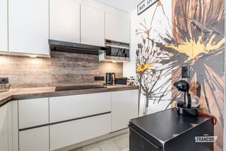 Op een gunstige ligging in de De Smet de Naeyerlaan vinden we dit gezellige duplex-appartement, gelegen op de 4de verdieping van een verzorgde residentie met lift. Bij het betreden van het appartement komen we terecht in een aangename leefruimte en een aanpalende keuken. De keuken werd reeds vernieuwd en is uitgerust met alle nodige toestellen. Op dezelfde verdieping bevindt zich een praktische berging met aansluitingen voor zowel een wasmachine als een droogkast. Verder is er op dit niveau een gastentoilet aanwezig alsook nog een ruime overloop die eventueel kan worden ingericht als slaaphoek of bijvoorbeeld een bureau.<br /><br />Via de hal bereiken we de bovenverdieping. Hier vinden we de slaapkamer, een recent gerenoveerde badkamer en een afzonderlijk toilet. <br /><br />Het appartement wordt verwarmd via centrale verwarming op aardgas. De verwarmingsketel werd recent vernieuwd. De elektrische installatie werd gekeurd en is conform. Als extra troef beschikt de residentie over een fietsenberging.<br /><br />Stedenbouwkundige inlichtingen zijn in aanvraag. <br /><br />