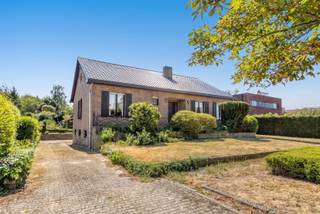 <p><span>Nestled in a green oasis of tranquility, in a strategic yet peaceful location within a highly sought-after, low-traffic, and child-friendly residential neighborhood—and yet close to major access roads—we are delighted to offer you this spacious home, just 20 minutes from Leuven. The property is situated on a beautifully oriented lot and offers an ideal combination of space, privacy, and accessibility. This home features a usable living area of 250 m². On the ground floor, you’ll find an entryway with a separate guest restroom and a bright, cozy living area that opens onto the sun-drenched terrace, a wonderful place to relax. Also on this floor, you’ll find a kitchen with a view of the garden, three full-sized bedrooms, and a bathroom. The first floor features a spacious attic that offers numerous possibilities. This open space can be finished and laid out entirely according to your own wishes and needs, making it perfect for creating additional bedrooms, a hobby room, an office, or a multipurpose living space. An ideal opportunity for anyone looking for additional living space. The home also features a full basement and an attached garage with space for multiple cars. Finally, you’ll enjoy a low-maintenance garden where you can relax in peace and privacy and experience a year-round vacation-like atmosphere right here at home. The spacious home, the cozy garden with plenty of privacy, the well-oriented lot, the central yet quiet location, and its setting on a low-traffic street are undeniable advantages. In short, this home with an absolutely prime location, situated in a rural and idyllic residential setting, is a unique opportunity and definitely worth a visit. For quick decision-makers!</span></p><p><span> </span></p>