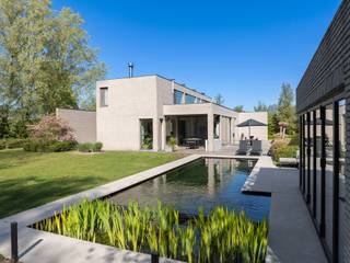 <p><strong>Exclusieve moderne villa met zwemvijver in een groene omgeving<br /><br /></strong>Op een uitzonderlijk mooi perceel van ca. <strong>2.464 m²</strong>, discreet gelegen aan het einde van een doodlopende straat, bevindt zich deze <strong>energiezuinige, hedendaagse villa</strong> die luxe, comfort en privacy perfect combineert. De woning is omgeven door groen en biedt een unieke woonbeleving in alle rust, zonder in te boeten aan bereikbaarheid.</p>
<p>De villa beschikt over <strong>drie volwaardige slaapkamers, twee badkamers, een aparte bureauruimte</strong>, een royale leefruimte met open haard en maatwerk kasten, een luxueuze leefkeuken met hoogwaardige toestellen en coffee corner, een bijkeuken, een ruime kelder en een <strong>dubbele inpandige garage</strong>.</p>
<p>De elegante inkomhal met vestiaire en gastentoilet leidt naar de lichtrijke leefruimte met grote raampartijen en een prachtig zicht op de tuin. Aansluitend bevindt zich een kantoorruimte met uitzicht op de koivijver — ideaal voor wie wonen en werken wil combineren. De volledig uitgeruste keuken geeft rechtstreeks toegang tot het (deels) overdekte terras en de tuin.</p>
<p>Op de verdieping bevindt zich de master suite met dressing, ensuite badkamer en privatief terras, evenals twee ruime slaapkamers, een douchekamer, een apart toilet en een wasplaats.</p>
<p>De tuin vormt een ware private wellness-oase, met een stijlvolle zwemvijver en een elegant poolhouse (± 7 jaar oud) — perfect om in alle seizoenen te genieten van rust, privacy en ontspanning.</p>
<p><strong>Extra troeven:</strong></p>
<ul>
<li>
<p>Geothermische warmtepomp</p>
</li>
<li>
<p>Zonnepanelen met groenestroomcertificaten</p>
</li>
<li>
<p>Putboring</p>
</li>
<li>
<p>Airconditioning in de slaapkamers</p>
</li>
<li>
<p>Domotica & geïntegreerde muziekinstallatie</p>
</li>
<li>
<p>Videofoon</p>
</li>
<li>
<p>Robotmaaier</p>
</li>
</ul>
<p>Een <strong>uitzonderlijke eigendom</strong> voor wie op zoek is naar luxe, ruimte, privacy en hedendaags wooncomfort op een toplocatie.</p>
<p>Voor meer informatie of een bezoek aan deze mooie villa neem contact op met sigalit@reds.be - 0475 66 84 74</p>