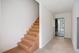 Koop aan 6% BTW* - Deze ruime, energiezuinige woning is gelegen in een doodlopende straat op wandelafstand van het centrum van Hoevenen. Winkels, scholen en openbaar vervoer bevinden zich allen in de nabije omgeving en ook de centra van Kapellen en Stabroek zijn slechts enkele kilometers van het pand verwijderd. De woning werd recent gebouwd in 2025, voldoet aan de huidige bouwnormen en kan genieten van een moderne uitstraling en een hoogwaardige afwerking. Zo werd het pand uitgerust met een ventilatiesysteem, is het voorzien van 7 zonnepanelen en profiteert het van een super gunstig EPC-label A. Binnenkomen doet u via een ruime, aparte inkomhal op een tijdloze tegelvloer. Vanuit de inkomhal loopt u door naar de woonkamer, dewelke samen met de eetkamer en de keuken één gigantische leefruimte vormt. Daglicht valt hier overvloedig binnen via een lichtkoepel en een groot schuifraam richting de tuin. Op de vloer ligt een mooie keramische tegel met parket-look, dewelke de ruimte een extra gezellige uitstraling geeft. De open keuken werd tevens voorzien van alle hedendaags comfort. Verder vindt u op het gelijkvloers nog een inpandige garage met automatische poort en een apart gastentoilet. De houten trap in de inkomhal leidt naar de 1e verdieping waar u de 1e erg grote slaapkamer, een apart toilet, een praktische berging/wasplaats en een luxueuze badkamer met ligbad, inloopdouche en dubbele wastafel met meubel kan terugvinden. Via een volwaardige trap bereikt u verder nog de 2e verdieping, waar zich nog eens 2 riante slaapkamers bevinden. Het perceel heeft een totale oppervlakte van 238m². De toffe, volledig omheinde tuin is erg netjes aangelegd met een terras en is west georiënteerd, waardoor u er de hele namiddag/avond heerlijk van het zonnetje kan profiteren. Uw wagen kan u makkelijk parkeren in de inpandige garage. <br />*Contacteer één van onze medewerkers voor meer info over de voorwaarden!