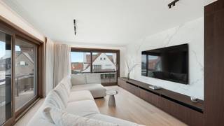Res. Duinhove. <br /><br />In een stijlvolle villaresidentie, op een uiterst gegeerde ligging vlak bij het Albertstrand, bevindt zich dit prachtig gerenoveerde duplex-appartement. Dankzij de uitzonderlijke hoekligging en de ideale zuidgerichte oriëntatie geniet de woonruimte de hele dag van een overvloed aan natuurlijk licht en een heerlijk open gevoel.<br /><br />Via de inkomhal met vestiaire en trap bereikt u de royale leefruimte, die de volledige zuidoostelijke hoek van het gebouw inneemt. De grote raampartijen creëren een aangename verbinding met buiten en geven uit op de zonnige terrassen die de leefruimte rondom omringen. Hier geniet u op elk moment van de dag van zon, rust en privacy. De ruime eetplaats sluit harmonieus aan op de moderne, volledig uitgeruste keuken, die zowel functioneel als stijlvol werd ingericht.<br /><br />De bovenverdieping omvat drie volwaardige slaapkamers, waaronder twee ruime tweepersoonskamers. De master bedroom beschikt over een elegante ensuite badkamer. De twee overige slaapkamers delen een tweede, smaakvol afgewerkte badkamer. Een afzonderlijk gastentoilet op deze verdieping zorgt voor extra comfort.<br /><br />Dit instapklare duplex-appartement onderscheidt zich door zijn royale volumes, uitzonderlijke lichtinval, hoogwaardige renovatie en topligging op wandelafstand van het strand, de Zeedijk en alle voorzieningen. Een zeldzame opportuniteit, ideaal als stijlvolle vaste woonst of als exclusief tweede verblijf aan de Belgische kust.<br />Ref. A722