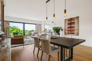 <p>This apartment enjoys an exceptional location in the sought-after district of Wilrijk. A place where nature, privacy and quality living go hand in hand, without compromising accessibility and comfort.</p>
<p>You enter through the entrance hall, which has been practically fitted with a guest toilet. The beautiful, high-quality parquet flooring immediately creates a warm atmosphere and flows elegantly into the sun-filled living area. Large windows establish a pleasant connection with the spacious terrace of no less than 9 m², where you can fully enjoy a peaceful view of the surrounding greenery. The trendy open-plan kitchen has been finished with high-quality materials, including a natural stone countertop, ceramic hob, dishwasher and built-in refrigerator. Adjacent, you will find a practical storage room with connections for a washing machine and dryer.</p>
<p>Furthermore, the apartment features 2 spacious bedrooms (21 m² & 14 m²) and, of course, a modern bathroom. Thanks to its clean lines, high-quality finishes and the thoughtful contrast between black and white materials, this space exudes pure elegance. The bathroom is equipped with a spacious walk-in shower, washbasin in a stylish vanity unit and toilet.</p>
<p>A cosy home where refinement meets a living experience you will enjoy every single day.</p>
<p>No more parking stress? Possibility to purchase a parking space for €20,000.00.</p>
<p>Technical details: Electrical installation compliant! Electric heating via a heat pump, high-efficiency glazing, insulated roof.</p>
<p>Urban planning information and soil certificate available. Asbestos-safe (but possibly not asbestos-free). The property is not located in a flood-risk zone (P-score D and G-score A). Renovation obligation does not apply.</p>