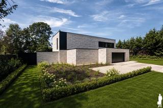 <p><strong><span>Exclusieve nieuwbouwvilla met hoogwaardige afwerking, zwembad en energielabel A in een groene omgeving nabij het centrum van Kasterlee.</span></strong> <strong>Op een prachtig perceel van ca. 1.466 m², rustig gelegen in een bosrijke omgeving nabij het centrum van Kasterlee, bevindt zich deze uitzonderlijke nieuwbouwvilla met een bewoonbare oppervlakte van ca. 400 m². Deze luxueuze woning combineert een stijlvolle architectuur met hoogwaardige materialen, een bijzonder ruimtelijk gevoel en een maximaal wooncomfort.<br /><br />Indeling:<br /></strong><strong><span>Gelijkvloerse verdieping</span></strong><br /><span>Via de ruime inkomhal met vestiaire en gastentoilet betreedt u de lichtrijke leefruimtes. De gezellige zithoek en eethoek genieten dankzij de grote raampartijen van een prachtig zicht op de tuin en zorgen voor een aangename verbinding tussen binnen- en buitenruimte.</span></p>
<p><span>Aansluitend bevindt zich de open leefkeuken, uitgevoerd met kwalitatieve materialen en uitgerust met hoogwaardige toestellen. De keuken biedt alle hedendaags comfort en beschikt onder meer over een koelkast, vriezer, wijnkoeler en Quooker-kraan. Verder omvat het gelijkvloers een praktische wasplaats met aansluitingen voor wasapparatuur, een aparte berging, een dubbele inpandige garage en een tuinberging met volledig ingerichte douchekamer.</span></p>
<p><strong><span>Eerste verdieping</span></strong><br /><span>De eerste verdieping biedt een comfortabele nachtzijde met een ruime masterbedroom, voorzien van een stijlvolle ensuite badkamer en dressing. De badkamer beschikt over een ligbad, ruime regendouche, dubbele wastafel en toilet. </span><span>Daarnaast bevinden zich op deze verdieping een praktische bureaukamer, een tweede badkamer met dubbele wastafel, regendouche en toilet, twee bijkomende slaapkamers en een ruime hobbykamer. Hierdoor beschikt de woning over vijf volwaardige slaap- of werkkamers, geschikt voor diverse woonbehoeften.</span></p>
<p><strong><span>Buitengebeuren</span></strong><br /><span>Ook buiten wordt het luxueuze karakter volledig doorgetrokken. De tuin wordt volledig aangelegd en voorzien van een verwarmd zwembad van 8 x 3,5 meter met sfeervolle ledverlichting. Het ruime terras rondom het zwembad wordt uitgevoerd in hoogwaardige materialen en vormt de ideale plek om te genieten van rust en privacy. </span><span>Verder worden alle buitenvoorzieningen zorgvuldig afgewerkt, waaronder buitenarmaturen, tuinverlichting en zwembadverlichting. Het poolhouse wordt uitgerust met een aparte douche en toilet. Een robotmaaier wordt eveneens inbegrepen.</span></p>
<span>Bijzonderheden:</span> <br />- Volledig afgewerkte nieuwbouwvilla, gerealiseerd met hoogwaardige en duurzame materialen en een uitzonderlijk luxueus afwerkingsniveau<br />- Bewoonbare oppervlakte van ca. 400 m²<br />- 5 slaapkamers <br />- Dubbele inpandige garage <br />- Energielabel A <br />- Airconditioning in alle ruimtes <br />- Voorzien van warmtepompen, thuisbatterij en zonnepanelen<br />- De woning beschikt over 2 badkamers en 1 volwaardige douchekamer<br />- Verwarmd zwembad en poolhouse<br />- Tuin aangelegd, inclusief robotmaaier<br />- In alle ruimtes reeds ingebouwde spotjes voorzien<br />- Buitenarmaturen, tuinverlichting en zwembadverlichting inbegrepen<br />-<strong> Mogelijkheid tot aankoop aan 6% btw, onder voorwaarden</strong>