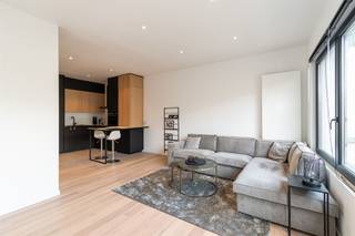 <p><span>Rustig wonen in een gegeerde buurt<br /></span><span><br />In de </span><span>Joris Helleputtestraat</span><span>, een rustige eenrichtingsstraat met charmante woningen en voortuinen, bevindt zich dit </span><span>volledig gerenoveerde appartement op de eerste verdieping</span><span>. De ligging is bijzonder aangenaam: residentieel en groen, met het </span><span>Te Boelaerpark</span><span> en het </span><span>Boekenbergpark</span><span> op wandelafstand. Winkels, horeca, openbaar vervoer, Velo‑station en vlotte verbindingen richting Ring en Singel maken dit een uiterst praktische locatie.<br /><br /></span></p><p><span>Licht, ruimte en een tijdloze afwerking</span><span><br />De leefruimte vormt het hart van het appartement en geniet van een </span><span>uitzonderlijke lichtinval</span><span> dankzij de grote raampartij. De volle parketvloer en neutrale afwerking creëren een warme, rustige sfeer. Er is voldoende ruimte voor zowel een gezellige zithoek als een eethoek, waarbij verschillende indelingen mogelijk zijn naargelang je woonstijl of seizoen.</span></p><p><span>Aansluitend bevindt zich de </span><span>volledig geïnstalleerde keuken</span><span>, praktisch ingericht en afgewerkt met een onderhoudsvriendelijke tegelvloer. Ze is uitgerust met koelkast, vriezer, vaatwasser, keramische kookplaat, dampkap, combi‑oven en spoelbak. Het greeploze maatwerk in zwart en warm hout zorgt voor een strak en hedendaags geheel. Het ontbijthoekje aan het keukenblok vormt een leuke extra.<br /><br /></span></p><p><span>Twee rustige slaapkamers en terras</span><span><br />De twee slaapkamers zijn gelegen aan de achterzijde van het gebouw en genieten van </span><span>rust en groen zicht</span><span>. De kleinste slaapkamer geeft toegang tot het </span><span>zuidoostgerichte terras</span><span>, een fijne plek om ’s morgens van de zon te genieten. Ideaal voor een eerste koffie of een rustig moment buiten.<br /><br /></span></p><p><span>Badkamer, berging en extra comfort</span><span><br />De badkamer is stijlvol en kwalitatief afgewerkt met tegels op vloer en wanden, zwarte kranen en accessoires, en beschikt over een </span><span>inloopdouche, lavabo met spiegelkast, toilet en handdoekradiator</span><span>. Aansluitend aan de badkamer bevindt zich een praktische berging met condensatieketel en aansluiting voor wasmachine.</span></p><p><span>Verder beschikt het appartement over een </span><span>kelderberging</span><span> en een </span><span>fietsenberging</span><span>. Parkeren kan vlot in de straat.</span></p><p><span> </span></p>