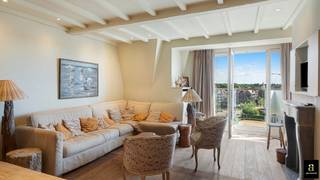 <span>Prachtig en lichtrijk penthouse van 110 m², gelegen op de vijfde verdieping van een residentie op een uitzonderlijke ligging aan de Kustlaan, in het hart van het Zoute. Op slechts 50 meter van het strand en vlak bij de winkels en restaurants geniet het appartement van een perfecte zuidoriëntatie en een volledig vrij panoramisch zicht van 180° over de minigolf, het klooster en het karakteristieke villalandschap van het Zoute. Het appartement werd begin jaren 2000 smaakvol gerenoveerd door Dominique Koch en onderscheidt zich door zijn elegante “Long Island”-stijl, kwalitatieve afwerking en uitstekende staat van onderhoud. Indeling: vestiaire, twee afzonderlijke toiletten, aangename leefruimte met open haard en eetplaats, uitgevend op een brede raampartij met verplaatsbare panelen waarmee een gezellige, zuidgerichte inpandige terrasruimte kan worden gecreëerd, volledig zonder inkijk. Volledig uitgeruste open keuken en afzonderlijke wasruimte.</span><br /><span>Het nachtgedeelte omvat drie ruime slaapkamers, die elk plaats bieden aan een groot tweepersoonsbed en beschikken over een raam, lavabo en ingemaakte kasten. Een badkamer, douchekamer, talrijke bergruimtes, een veiligheidsdeur en een privatieve kelder vervolledigen het geheel. Mogelijkheid tot aankoop van een ruime afgesloten garagebox in de parking recht tegenover de residentie, met voldoende plaats voor zowel een wagen als fietsen. Aan de voet van het gebouw is bovendien een zone voorzien voor het stallen van fietsen, uitgerust met fietsbeugels. Een uitzonderlijk appartement dat licht, panoramische zichten, comfort en een gegeerde ligging aan één van de meest geliefde lanen van het Zoute perfect combineert</span>