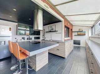 <p>Welcome to this exceptionally spacious home, centrally located and offering a wealth of possibilities. The home features several full floors, spacious living areas, and no fewer than 4 bedrooms, with the potential to create additional rooms or functional spaces.</p><p>On the ground floor, there is a very spacious garage/storage area, suitable for multiple cars, storage, a hobby room, or possibly a combination of living and working spaces. This makes the property particularly appealing for those seeking extra space or practical solutions at home.</p><p>The home includes, among other features, a light-filled living area, a spacious kitchen, multiple bathrooms, bedrooms, and a large attic that can be further customized to your liking. Thanks to the 36 solar panels on the property, the home also offers a significant energy advantage.</p><p>Although the home could use some refreshing or finishing touches in certain areas, it offers, above all, exceptional space and potential.</p><p>Are you looking for a spacious home with a garage, storage options, and potential for expansion? Then this property is definitely worth a visit.<br />For more information or to schedule a visit, email info@property-vastgoed.be</p>