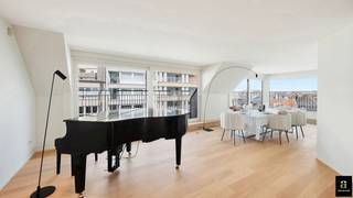 <p><span>Subliem zonnig duplexappartement met ruime terrassen en zijdelings zeezicht, op enkele stappen van de Zeedijk in Knokke.</span></p>
<p><span>Via de inkomhal met gastentoilet, vestiaire en ruime wasplaats komt u in de zeer lichtrijke leefruimte, die rechtstreeks uitgeeft op twee terrassen, respectievelijk zuid- en oostgericht, met zijdelings zeezicht. Dankzij de grote en talrijke raampartijen op het zuiden, oosten en westen genieten de woonkamer, eetplaats, zithoek, keuken en bureau van een uitzonderlijke lichtinval en veel zon.</span></p>
<p><span>De ruime, zonnige zithoek beschikt over een ingebouwde gashaard en tal van maatkasten. Door de raampartijen op zowel het oosten als het zuidwesten baadt deze ruimte in het licht.</span></p>
<p><span>De prachtige, open keuken is zeer kwalitatief afgewerkt in marmer en voorzien van Miele-toestellen, een gezellig eiland met barkrukken en twee grote ingemaakte Amerikaanse koelkasten. De keuken geeft rechtstreeks toegang tot een ruim, zuidwestgericht terras. Aansluitend bevindt zich een ruime bureauruimte met veel maatkasten, eveneens uitgevend op het zuidgerichte terras.</span></p>
<p><span>Via de prachtige trap bereikt u de verdieping.</span></p>
<p><span>De ruime masterbedroom beschikt over tal van eiken maatkasten, een grote tv-wand en een ensuite badkamer met toilet, Italiaanse inloopdouche en wastafel, volledig afgewerkt in prachtige mortex. De tweede volwaardige slaapkamer beschikt over een tweepersoonsbed en mooie eiken maatkasten. De derde slaapkamer is ingericht met een ingemaakt stapelbed, een afzonderlijk eenpersoonsbed en een ensuite badkamer met inloopdouche, toilet en wastafel in mortexafwerking. Deze slaapkamer kan ook als volwaardige slaapkamer ingericht worden met een dubbel bed.</span></p>
<p><span>Privatieve kelder aanwezig in het gebouw. Mogelijkheid tot aankoop van twee garageboxen in het gebouw.</span></p>
<p><span>Superlatieven schieten tekort om dit prachtige appartement te omschrijven. Absoluut een bezoek waard.</span></p>