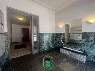 Op een boogscheut van Smedenpoort en 't Zand, en van het station bevindt zich dit ruim appartement op eerste verdieping in de aangename residentie Atlanta. Op oppervlakte van 107 m² + maar liefst 16 m² Z.O.-gericht terras (die tot deel in namiddag zon biedt). Ideale locatie met heel wat buurtwinkels, supermarktjes, nabijheid van alle voorzieningen, maakt dit bijzonder mooi wonen. Er is een bovengrondse èn ondergrondse gemeenschappelijke fietsenbergplaats, en het appartement heeft ook een privatieve kelderberging (droog en geriefelijk). <br /><br />Het op te frissen appartement telt 2 (mog. tot 3) slaapkamers en heeft een een authentieke seventies-vibe die terug kan gesmaakt worden, al is er wel wat opfriswerk nodig. De ruimtes zijn aangenaam en mooi in proportie. Wij betreden het appartement via een grote inkomhal, er is een gastentoilet, vestiaire-nis, een bureau die uitgeeft op een ruime living (voorzien van parket, + karaktervolle schouw, niet meer in gebruik), een verzorgde doch wat oudere keuken, een tussenhal met berging, nachthal, badkamer, 2 slaapkamers (grote en middelgrote) waarvan de middelgrote uitgeeft op een riant zonnig terras (enige appartement in de residentie die een groot terras heeft!).<br /><br />Bij het appartement is er een bovengrondse gesloten garagebox bij te kopen aan 32.000 EUR, rekening houdend met de ligging is dit zeker een interessante meerwaarde.<br /><br />De bijzonder gunstige EPC-score 128 Kwh/m/j is te danken aan de vernieuwde ramen (met thermisch/akoestisch isolerend dubbel glas) in PVC en ook aan de recente HR-condensatie-gaswandketel (Buderus).<br /><br />Bijzonder leuk wonen, de ligging is beslist een heel grote troef, op fiets- en wandelafstand van station en zoveel meer + vlot bereikbaar (men zit zo op de expressweg richting kust of binnenland). Boek uw bezoek: 0476 70 60 26 of thierry@puurvastgoed.be