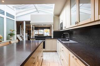 Looking for a home where living and working can be perfectly combined? Or do you dream of a kangaroo house, a co-housing project, or simply lots of space for a large family? <br /><br />This home consists of two parts, with the front part being a multipurpose space on the ground floor, ideal as commercial space such as a practice or office, or as living space. The first floor has two bedrooms and another living space. <br /><br />The second part is located at the rear and consists of a cozy living room with dining area and fitted kitchen, as well as a bathroom on the ground floor. On the first floor, there is a spacious bedroom. <br /><br />This property was completely renovated in 2015. Central heating is oil-fired and is also equipped with a pellet stove and air conditioning. <br /><br />Outside there is a cozy terrace, a fully enclosed garden, and an extra structure for storage/hobbies. <br /><br />Located in Aspelare with easy access to shops, schools, and public transport. <br /><br />Curious to find out more? Call Isabelle on 0498/10.69.56.