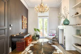 In de geliefde Bouwmeestersstraat in Sint-Amandsberg, op een boogscheut van de Gentse binnenstad, staat deze statige herenwoning die uitblinkt in charme en elegantie.De ruime woning (275 m² bew. opp.) verwelkomt je met hoge plafonds, warme houten vloeren en verfijnde details die de authenticiteit van weleer uitstralen. Dankzij de grote ramen geniet elke kamer van overvloedig daglicht, waardoor de ruimtes een open en luchtige sfeer krijgen.Indeling:- Sous-sol met eetplaats, keuken, proviandberging en toegang tot de buitenruimte- 1ste verdieping met zitplaats en living, afzonderlijk toilet onder de trap- 2de verdieping met 2 slaapkamers, dressing en badkamer (2 lavabo's, wc, bad en douche)- 3de verdieping met 3 slaapkamers- Zolderverdieping met vaste trap die verder dient afgewerkt te worden (2 slaapkamers mogelijk).De stadstuin met waterpartij vormt een groene, intieme plek midden in de stad – ideaal om te ontspannen en in alle rust te genieten van een vleugje mediterrane sfeer.Het huis is bijzonder geschikt voor een groot gezin of voor wie op zoek is naar veel ruimte en mogelijkheden. Het combineert grandeur en gezelligheid, en biedt tegelijk de kans om verder te personaliseren en te moderniseren. Extra info:- De garage te zien aan de voorgevel behoort niet toe aan dit huis maar aan de buur.- 595.000 EUR is een richtprijs.