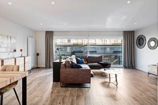 Dit stijlvol gerenoveerde appartement met een bewoonbare oppervlakte van ca. 110 m² is centraal, doch rustig gelegen in Schoten. Gelegen in een goed onderhouden gebouw met lift, combineert dit appartement comfort, ruimte en een hoogwaardige afwerking.<br /><br /><strong>Indeling</strong><br />Via de ruime inkomhal met ingemaakte vestiairekast en apart gastentoilet (met handenwasser) betreedt u het appartement.<br /><br />Achter een elegante glazen deur bevindt zich de riante en lichtrijke woonkamer, afgewerkt met een keramische parketvloer, die zorgt voor een warme en tijdloze uitstraling.<br />De open leefkeuken is hyper-geïnstalleerd en voorzien van kwaliteitsvolle toestellen van AEG en Novy, waaronder een vaatwasser, zelfreinigende oven, koelkast, diepvriezer, inductiekookplaat en dampkap.<br /><br />De badkamer is ruim en stijlvol ingericht met een inloopdouche en een lavabomeubel met spiegelkast.<br /><br />Verder beschikt het appartement over twee volwaardige slaapkamers, eveneens afgewerkt met een doorlopende keramische parketvloer. Achteraan bevindt zich een terras aan de tweede slaapkamer, terwijl u vooraan geniet van een balkon aan de woonkamer.<br /><br />Tot slot is er een privatieve kelderberging en een ondergrondse garage welke verplicht erbij aan te kopen is voor € 25.000.<br /><br /><strong>Bijzonderheden</strong><br />+ Volledig en stijlvol gerenoveerd (2019)<br />+ Nieuwe ramen met vliegenramen<br />+ Centrale, doch rustige ligging<br />+ Goed onderhouden gebouw met lift<br />+ Ruim en lichtrijk appartement<br />+ Ondergrondse garage en kelderbering<br />Bew. opp. volgens EPC