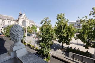 Karaktervol appartement met ruim terras op toplocatie<br /><br />Op een uitzonderlijke locatie aan de Groenplaats, met uitzicht op het Hilton Hotel en op wandelafstand van de Grote Markt, de Meir en de Wilde Zee, bevindt zich dit charmante appartement in een kleinschalige residentie.<br /><br />Via de stijlvolle inkomhal bereikt u het appartement op de eerste verdieping. De ruime en lichtrijke leefruimte met parketvloer biedt een prachtig uitzicht op de Groenplaats. Aansluitend bevindt zich de luxueus uitgeruste open keuken, voorzien van alle hedendaagse comfort, een kookeiland en een gezellige ontbijthoek.<br /><br />Vanuit de keuken leidt een korte trap naar het lager gelegen deel. Hier bevindt zich een praktische bureauruimte in de gang, met toegang tot het rustig gelegen terras. Op dit niveau vindt u tevens een ruime slaapkamer met een ensuite badkamer, uitgerust met een lavabo, douche en toilet en een wasplaats.<br /><br />Via een kleine trap bereikt u het hoger gelegen deel, waar zich een tweede ruime slaapkamer bevindt met een ensuite dressing. Daarnaast is er een volledig uitgeruste, royale badkamer.<br /><br />Een absolute troef van dit appartement is het gezellige en rustig gelegen terras, waar u in alle privacy kunt genieten van een oase van rust, midden in het bruisende stadscentrum.<br /><br />Daarnaast is er de mogelijkheid om een staanplaats aan te kopen in de naastgelegen residentie voor € 35.000.
