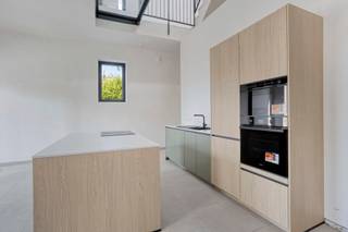 This unique loft apartment is located in the rural and peaceful town of Sint-Pieters-Kapelle, housed in a fully renovated former school building. Here, authentic charm and contemporary living comfort go hand in hand. Through the light-filled entry hall, you enter the spacious living area, which flows seamlessly into the open kitchen, where large windows provide an abundance of natural light and a beautiful view of the patio and garden.

On the first floor, there are two spacious bedrooms and a stylish bathroom featuring both a bathtub and a walk-in shower. The attic floor offers two additional bedrooms and provides access to a second terrace.

The home is exceptionally energy-efficient thanks to underfloor heating and solar panels, resulting in a favorable EPC rating and a pleasant living environment. In addition, you’ll enjoy an exemption from cadastral income tax for the first five years. The home also features a private garden, private parking spaces, and a shared bicycle storage area.

**Highlights:**

* Unique loft apartment in a renovated school building
* Quiet, green location
* 4 full-sized bedrooms
* Underfloor heating and solar panels
* Exemption from cadastral income tax for the first 5 years
* Option to purchase at registration tax rates
* Private garden, parking spaces, and bicycle storage

A unique opportunity for those seeking character, space, and sustainable living comfort.
