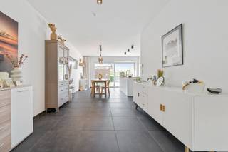 In een rustige en bijzonder gegeerde verkaveling te Melsele, waar elke woning haar eigen karakter en architecturale uitstraling heeft, bevindt zich deze instapklare en opvallend verzorgde gezinswoning met een bewoonbare oppervlakte van 179 m² op een perceel van 148 m². Wat meteen opvalt bij het binnenkomen, is de aangename lichtinval en de warme, uitnodigende sfeer die doorheen de volledige woning voelbaar is. De leefruimte vormt een mooi geheel met de open, moderne keuken, uitgerust met alle toestellen en een centraal eiland waar koken en samenzijn naadloos samenkomen. Dankzij het grote schuifraam vloeit de leefruimte moeiteloos over in het zonnige terras en de volledig aangelegde, afgesloten tuin.<br />De woning beschikt over vier volwaardige slaapkamers en twee badkamers, waarvan één met ligbad en één met douche, wat zorgt voor een ideale combinatie van comfort en flexibiliteit voor elk gezin. Een aparte wasruimte verhoogt het praktische gemak in het dagelijkse leven. Ook op vlak van energiezuinigheid scoort deze woning sterk met onder andere 10 zonnepanelen, wat bijdraagt aan een duurzame en toekomstgerichte woonervaring. Achteraan het perceel bevindt zich een afzonderlijke garagebox, bereikbaar via een handige achteruitweg die tevens perfect is voor fietsen.<br />Dit is een woning waar u zich meteen thuis voelt, gelegen in een omgeving waar zelden iets te koop komt. Een unieke kans voor wie op zoek is naar comfort, licht en een warme thuis in een sterke regio.