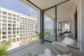 This exceptional flat is situated in one of the most sought-after locations in Nieuw Zuid, within the distinctive building designed by architect Max Dudler. Its unusually wide façade offers a direct and unobstructed view of the Scheldt, both from the living area and from the kitchen.<br /><br />The large terraces on either side of the flat offer sweeping views over Antwerp’s revitalised quays and the historic city centre. At sunrise and sunset, the panorama across the river and the city constantly shifts in atmosphere.<br /><br />Inside, the light, open-plan living area and kitchen form the beating heart of the home. Floor-to-ceiling windows allow daylight to flood in unhindered, whilst walnut and marble create a timeless, warm ambience. The kitchen, featuring an imposing marble cooking island, is as functional as it is aesthetically refined.<br /><br />The master suite serves as a private retreat, featuring a dressing room and a bathroom with a freestanding bath, walk-in shower and double washbasin, stylishly finished with Vola taps. Two additional bedrooms, served by a second fully-equipped shower room, make the flat equally suitable for a family as it is for those needing space for guests or a home office.<br /><br />Throughout the entire flat, the choice of materials reflects a refined, well-considered finish down to the smallest detail. Living comfort is complemented by three parking spaces and a spacious cellar storage room.<br /><br />Living in Nieuw Zuid means living on the banks of the Scheldt, with the refurbished quays and the historic city centre within easy reach, in a building of outstanding architectural quality. A unique opportunity for anyone looking for space, light and views in Antwerp.