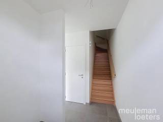 Cette maison moderne et économe en énergie est située dans un nouveau lotissement à Hertsberge. Il s'agit de la maison mitoyenne à gauche. Le lotissement a été réalisé en 2025-2026 et est équipé des techniques les plus récentes offrant un confort de vie contemporain.<br /><br />Au rez-de-chaussée, vous trouverez un hall d'entrée avec toilettes pour invités et lavabo, suivi d'un lumineux espace de vie avec une cuisine ouverte entièrement équipée. La cuisine comprend une plaque à induction, une hotte, deux éviers (grand et petit), un lave-vaisselle intégré, un four à convection et un grand réfrigérateur encastré. <br />À côté de la cuisine se trouve une buanderie spacieuse et fonctionnelle donnant accès à l'avant de la maison.<br /><br />Au premier étage, on trouve un hall de nuit, un WC séparé, trois chambres doubles ainsi qu'une chambre simple, une salle de bain entièrement équipée avec douche à l’italienne, baignoire et double lavabo. Un espace de rangement est également prévu à cet étage.<br /><br />Le salon et la cuisine donnent directement accès au jardin et à la terrasse. Le jardin sera aménagé avec une pelouse et un abri de jardin extérieur.<br /><br />La maison est également équipée de panneaux solaires, du chauffage par le sol et d’une allée privée. <br />La peinture est terminée en finition et des rails pour rideaux ont été installés.<br /><br />Pour une visite, vous pouvez réserver un créneau horaire via notre site web meuleman-loeters.be.