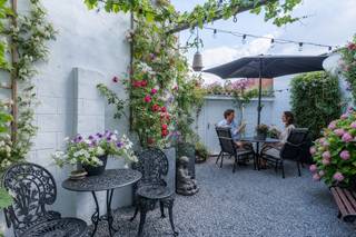 <h2>Wonen en werken in perfecte harmonie<br /><br />ZATERDAG 1 AUGUSTUS OPEN HUIS (op afspraak) Schrijf u snel in!<br /><span></span></h2>
<p>Bent u op zoek naar een eigendom dat wonen, werken en genieten moeiteloos combineert? Dan zal deze instapklare, energiezuinige woning u ongetwijfeld weten te verrassen. Achter de verzorgde gevel schuilt een bijzonder veelzijdig pand waar comfort, karakter en functionaliteit hand in hand gaan.</p>
<p>Een van de absolute troeven is de volledig afgescheiden handelsruimte op het gelijkvloers, voorzien van een <strong>eigen inkom en een afzonderlijk toilet</strong>. Hierdoor blijven privé en professioneel perfect gescheiden, wat dit eigendom uitermate geschikt maakt voor vrije beroepen, een praktijk, kantoor, boetiek of andere zelfstandige activiteiten. Wenst u geen handelsruimte? Dan kan deze eenvoudig opnieuw geïntegreerd worden in de woning, waardoor u het woonvolume aanzienlijk vergroot en tal van extra mogelijkheden creëert.</p>
<p>Op de leefverdieping geniet u van een aangename, lichtrijke woonkamer waar de sfeervolle haard meteen een warme en uitnodigende uitstraling creëert. Aansluitend bevindt zich de stijlvolle, volledig geïnstalleerde keuken, waar kwaliteit, comfort en een tijdloos design samenkomen – de ideale plek om uitgebreid te koken en gezellig samen te zijn.</p>
<p>De tweede verdieping biedt <strong>twee slaapkamers</strong> en een luxueus afgewerkte badkamer met een royale inloopdouche, dubbele wastafel en toilet. Een stijlvolle ruimte waar ontspanning en comfort centraal staan.</p>
<p>Via de woning bereikt u de verrassend sfeervolle, mediterrane stadstuin. Deze onderhoudsvriendelijke buitenruimte vormt een oase van rust en privacy, ideaal om te genieten van lange zomeravonden of gezellige momenten met familie en vrienden. Achteraan bevindt zich bovendien een garage/hobbyruimte met achteringang, wat zorgt voor extra bergruimte, parkeermogelijkheden of een perfect atelier.</p>
<p>Ook de ligging is een absolute meerwaarde. Het eigendom bevindt zich op een bijzonder centrale locatie, op wandelafstand van het centraal station en met een vlotte verbinding naar de belangrijkste in- en uitvalswegen. Winkels, horeca, scholen en alle dagelijkse voorzieningen bevinden zich binnen handbereik.</p>
<p><strong>Een unieke eigendom met ongeziene flexibiliteit, waar comfortabel wonen, professioneel werken en ontspannen samenkomen op één toplocatie.</strong> Hier koopt u niet alleen een woning, maar vooral een eigendom dat zich moeiteloos aanpast aan uw levensstijl én toekomstplannen.</p>