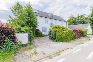 Deze karaktervolle voormalige dokterswoning (bouwjaar 1961) biedt een uitzonderlijke bewoonbare oppervlakte van maar liefst 439 m² en combineert ruimte, comfort en een strategische ligging langs de N60, centraal op de as Ronse – Oudenaarde.<br />De woning beschikt beneden over een indrukwekkend aanbod aan leef- en werkruimtes. Zo vindt u er een grote living met gashaard, een ruime keuken, een gezellig bureel, een bibliotheek, een praktische wachtzaal, een voormalige praktijkruimte, een opslagplaats en zelfs een wijnkelder. Dankzij deze veelzijdige indeling is de woning perfect geschikt voor grote gezinnen, zelfstandigen, vrije beroepen of wie gewoon graag royaal woont.<br />Boven beschikt de woning over 5 volwaardige slaapkamers, 2 badkamers en 4 toiletten. De vele ingemaakte kasten zorgen voor extra comfort en praktische opbergruimte.<br />Op technisch vlak geniet u van tal van hedendaagse voorzieningen, waaronder driedubbele beglazing, automatische poorten en rolluiken, een alarmsysteem, zonnepanelen en een verwarmingsinstallatie op aardgas.<br />Buiten wacht een aangenaam overdekt terras met daarboven een balkon, beide gericht op het mooie verzicht achteraan het perceel. De dubbele garage met sectionaalpoort biedt ruim plaats voor twee voertuigen en extra bergruimte.<br />Voor meer inlichtingen of een bezoek, contacteer Veronique 0483/676579