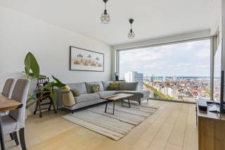 Welkom in de iconische Antwerp Tower, de maatstaf van modern wonen met een prachtig uitzicht over de stad. Dit exclusieve tweeslaapkamerappartement op de 17de verdieping biedt dan ook een unieke woonervaring. <br /><br />Doordat je op 17de verdieping leeft, woon je letterlijk boven het bruisende stadsleven. Winkels, cultuur, gastronomie en openbaar vervoer bevinden zich hier allemaal binnen handbereik. Vanuit het appartement stap je zo de De Keyserlei, de Meir of de Opera tegemoet. Tegelijkertijd geniet je, hoog boven de stad, van een uitzonderlijk gevoel van rust, privacy en ruimte. Een unieke woonplek die erin slaagt de dynamiek van Antwerpen, design, luxe en bovenal het uitzicht, te combineren tot een woonbeleving van een ander niveau. <br /><br />Via de centraal gelegen inkomhal, dewelke is voorzien van een toilet en een handige berging, heeft men toegang tot alle ruimtes van het appartement. De leefruimte beschikt over raampartijen die het levendige canvas van de stad weerspiegelen met aansluitend de goed uitgeruste open keuken. <br /><br />Verder zijn er nog twee slaapkamers die alle comfort en rust bieden en een badkamer met inloopdouche en wastafelmeubel.<br /><br />Het terras, ter bereiken vanuit de leefruimte en vanuit de slaapkamers, met uitzicht over de stad. <br /><br />Het comfort wordt alleen nog maar verhoogd door de aanwezigheid van een extra berging en een optioneel aan te kopen, ondergrondse parkeerplaats aan €50.000. (laadpaal wordt nog geïnstalleerd) <br /><br />EPC 58 = A