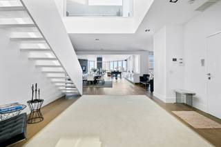 <div>
<div>
<div>
<p>This penthouse was renovated in 2017 by the Dutch interior architect Jan des Bouvrie. The apartment features a private elevator, a living area of 434 m², two large sun terraces totaling 130 m², three storage rooms, and one indoor parking space, with a second parking spot possibly available for purchase at €35,000. The entire apartment is secured with a keypad for triple security. There is colorful LED lighting, air conditioning, white high-gloss built-in cabinets, and Corian finishes. The open entrance hall on the sixth floor provides direct access to the large reception area, with a lounge and dining section, three designer gas fireplaces, and a fully equipped bar with Gaggenau appliances. These include a double fridge/freezer with ice maker, double wine fridge, professional coffee machine, combi-oven, dishwasher, and an instant hot water boiler. This floor also houses two bedrooms, each with a private bathroom equipped with a rain shower with mosaic tiles, double sink, and toilet. The master bedroom additionally features a double jacuzzi with built-in LED lighting. A floating staircase and an internal private elevator connect the sixth and seventh floors. On the seventh floor, there is a private lounge, dining area, library, kitchen with the same Gaggenau appliances as downstairs, and a third bedroom with a shower room. This floor has automatic sunshades and two sun terraces of 90 m² and 40 m². From here, you have a unique view of the Cathedral of Our Lady, the Boerentoren, and the city theater.</p>
</div>
</div>
</div>
<div>
<div></div>
</div>
<span><br /><br />Located in the heart of Antwerp city centre, this exclusive and luxurious duplex penthouse is a real feast for the eyes. Within walking distance of the famous Schuttershofstraat with its elegant shops and the Stadsschouwburg for optimal entertainment. Due to this ideal location, you can be in and out of the city in no time.<br /></span>