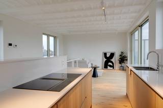 Tussen centrum Antwerpen en Zurenborg ligt een ware oase in de stad: het Groen Kwartier, met PAKT, koffiebar, winkels en fitness, vlakbij Berchem station en invalswegen.<br /><br />Indeling:<br />Dit appartement ligt op de vierde verdieping, toegankelijk met lift of trap. In de inkomhal vindt u een handige berging terug, een gastentoilet en een badkamer. De badkamer is voorzien van een ligbad, badkamermeubel en spiegelkast met verlichting. Verder vindt u hier nog 2 slaapkamers terug (13 en 11m²) en een douchekamer met inloopdouche. <br />Via de wenteltrap in de nachthal komt u in de lichtrijke leefruimte met open keuken, dewelke voorzien is van een prachtige parketvloer. De keuken is een volledig uitgeruste moderne keuken in een fineer eikenhout motief, afgewerkt met een inductiekookplaat met ingewerkte dampkap, composiet werkblad, dubbele spoelbak, koelkast, combi oven en vaatwasser. Grenzend aan deze ruimte kan u een ruim (18 m²) zuidgeoriënteerd terras terugvinden.<br /> <br />Troeven:<br />+ Nieuwbouw<br />+ Top locatie<br />+ Groot zuid terras<br />+ Gunstig EPC<br />+ Ruim en lichtrijk<br />+ Zicht op groen<br /><br />Heeft u interesse en wenst u een bezoek ter plaatse in te plannen? Surf naar onze website www.vbvastgoed.be en klik op de groene knop "ik ben kandidaat"!