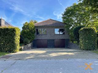 RUIME, RUSTIG GELEGEN SEVENTIES VILLA MET DUBBELE GARAGE EN TUIN! Woning bestaande uit: Gelijkvloers: inkomhal, 2 toiletten, lichtrijke woonkamer...