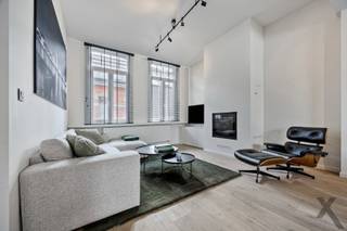 Op een absolute toplocatie in Schilde, op wandelafstand van het centrum en op een boogscheut van het gezellige kerkplein met hotspot Café Den Toren, presenteren wij deze prachtig gerenoveerde dorpswoning. Deze exclusieve eigendom combineert de authentieke charme van een karaktergevel, de hoogwaardige en uiterst smaakvolle binnenafwerking resulteren in onmiddellijk en zorgeloos genieten van alle luxe en comfort.
Bij het betreden van de woning ervaart u meteen een overweldigend gevoel van ruimte en elegantie. De riante, hoge plafonds trekken het daglicht rijkelijk naar binnen en versterken het open karakter. De verfijnde parketvloeren lopen naadloos door de leefruimtes en stralen een tijdloze warmte uit. Samen met de op maat gemaakte, stijlvolle raamdecoratie vormt dit een harmonieus geheel dat tot in de puntjes is verzorgd. In de sfeervolle zithoek geniet u tijdens koude winteravonden van de gezellige warmte van een moderne pelletkachel. De leefruimte sluit naadloos aan op een intieme, perfect ingesloten stadskoer. Deze buitenruimte is bewust compact gehouden, zodat u in alle rust, privacy en zonder onderhoud buiten kunt eten en relaxen.
Op de verdieping beschikt de woning over drie slaapkamers waarvan één ruime master bedroom, een tweede slaapkamer in gebruik als kantoor en de derde slaapkamer als combinatie dressing / logeerkamer en een moderne badkamer. Parkeercomfort in de dorpskern is bovendien gegarandeerd en inbegrepen in de vraagprijs: recht tegenover de woning bevindt zich een private ondergrondse staanplaats, ideaal voor het veilig stallen van fietsen of een compacte stadswagen. Een zeldzame opportuniteit voor wie op zoek is naar een instapklare woning met klasse en cachet in Schilde.