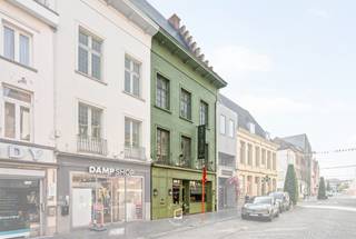 Karaktervol beschermd handelshuis op toplocatie in het hart van Oudenaarde<br />In de geliefde Nederstraat, op wandelafstand van de Grote Markt van Oudenaarde, bevindt zich dit uitzonderlijke handelshuis met een rijke geschiedenis en een unieke uitstraling. Het pand, momenteel gekend als Optiek Van de Velde, maakt deel uit van het beschermde erfgoed en staat geregistreerd als het prestigieuze Patriciërshuis 'Huis Vandermeeren' (Nederstraat 33-35, 9700 Oudenaarde). Vrij van handelshuur 01 AUG. 2026.  Met een grondopp. van 208 m² biedt dit karaktervolle gebouw tal van mogelijkheden voor handel, combinatie wonen-werken of een herbestemmingsproject, mits de nodige vergunningen. De handelsruimte op het gelijkvloers beschikt over een oppervlakte van circa 143 m² en geniet van een uitstekende commerciële zichtbaarheid in één van de meest gekende winkelstraten van de stad. De bovenliggende verdiepingen omvatten samen ongeveer 400 m² bruikbare oppervlakte en zijn reeds bereikbaar via een afzonderlijke toegang, wat extra potentieel creëert voor diverse invullingen. Het gebouw onderging recent omvangrijke restauratie- en renovatiewerken met respect voor zijn historische waarde. Zo werden de oude asbestleien en dakpannen volledig vervangen door hoogwaardige natuurleien in Maasdekking en werden nieuwe Velux-dakvlakvensters geplaatst  + dakisolatie. Daarnaast werd de authentieke trapgevel vakkundig gerestaureerd, werd een belangrijke eiken zolderbalk hersteld en kreeg het oorspronkelijke gevelmetselwerk een grondige renovatie met veldsteen en kalkmortel, volledig in lijn met de erfgoedvereisten. De effectieve uitvoering van deze werken startte in de zomer van 2024. CV AARDGAS. AFZONDERLIJKE METERS VOOR APP. EN COMMERCIEEL GELIJKVLOERS. Een zeldzame opportuniteit voor investeerders, ondernemers of liefhebbers van historisch vastgoed die op zoek zijn naar een prestigieus pand met uitstraling, ruimte en een uitstekende ligging in het historische stadscentrum van Oudenaarde.<br />Meer informatie of een bezoek ter plaatse? Contacteer ons voor een persoonlijke rondleiding door dit unieke erfgoedpand.
