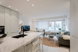Ontdek dit smaakvol en volledig gerenoveerd appartement, gelegen in een rustige zijstraat van de Zeedijk, op wandelafstand van het Driehoeksplein en het Albertplein. Een ideale combinatie van centrale ligging en rust.<br /><br />Bij het betreden van het appartement komt u in een ruime inkomhal met gastentoilet. De lichtrijke leefruimte straalt een aangename sfeer uit en sluit naadloos aan op de open, volledig ingerichte keuken.<br /><br />Het appartement beschikt over twee volwaardige slaapkamers, beide voorzien van ingemaakte kasten. Daarnaast is er een derde slaapkamer met stapelbed, ideaal als kinderkamer of extra slaapruimte. De ruime badkamer is uitgerust met een dubbele lavabo, inloopdouche en toilet.<br /><br />Dit appartement wordt volledig gemeubileerd verkocht en is dus instapklaar.<br />Een privatieve kelder in de residentie is inbegrepen, wat extra bergruimte biedt.