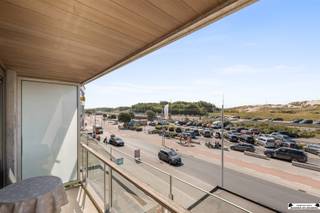 <p>Located on Kapelstraat, in the center of Bredene, is this beautifully maintained two-bedroom apartment. Thanks to its unique location with an unobstructed view of the dunes and shops just 20 meters away, this is an excellent choice as an investment, second home, or primary residence.</p><p>The apartment is currently rented out and offers a gross return of nearly 3.5%. It is possible to take over the lease from the current tenant. In addition, the lease for a locked garage (approx. €100/month) can also be taken over.</p><p>Take the elevator to the second floor. You’ll enter the bright living area with an open, fully equipped kitchen. The large windows and the wide sliding door leading to the front terrace provide an abundance of natural light and a beautiful, unobstructed view of the Bredene dunes.</p><p>Through the night hall, you’ll find a separate toilet, a practical storage room with connections for a washing machine and dryer, and the bathroom, equipped with a sink, bathtub, and shower.</p><p>At the rear of the apartment are two spacious bedrooms, one of which opens onto a sunny, south-facing terrace.</p><p><strong>Key features:</strong></p><ul><li>Unique view of the dunes, right in the heart of the city center</li><li>Ideal as an investment, second home, or primary residence</li><li>Two spacious bedrooms and two terraces </li><li>Option to rent a garage</li></ul><p><br />In short, a move-in-ready apartment in a prime location offering a great return on investment and all amenities within easy reach. Feel free to contact us for more information or to schedule a visit.</p>