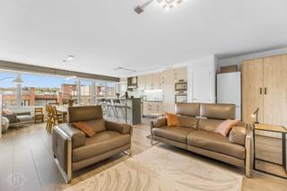 Dit vernieuwde 3-slaapkamerappartement ligt in de Fonteinstraat, een zijstraat van de levendige Brusselsestraat, pal in het centrum van Leuven en vlak bij winkels, supermarkten, bushaltes, campussen en Gasthuisberg. Met ca. 110 m², waarvan 100 m² bewoonbaar en 10 m² terras, combineert het ruimte, comfort en een zeer energiezuinig EPC-label A. Via de inkomhal met vestiairekasten aan weerszijden bereikt u de zeer ruime, lichtrijke leefruimte met open keuken en eiland, uitgerust met volledig vernieuwde toestellen. Verder zijn er drie slaapkamers, waarvan twee met airco (2022), een apart toilet en een badkamer met nieuwe douche. Vanop het terras op de zevende verdieping geniet u van een adembenemend uitzicht op de Sint-Pieterskerk en het hart van Leuven. De voorbije jaren werden tal van vernieuwingen uitgevoerd, waaronder hoogrendementsbeglazing, nieuwe radiatoren, vloeren, keukenapparatuur en sanitair. Aan de voorzijde wordt nog een zonnescherm met solarsysteem geplaatst. Ook het gebouw werd recent vernieuwd met onder meer renovatie van het dak, lift en gemeenschappelijke deuren. Extra troeven zijn een dubbele staanplaats in de overdekte garage en een privatieve kelderberging. De elektriciteit is conform en het appartement is asbestveilig. Kortom: een volledig up-to-date appartement met drie slaapkamers en twee staanplaatsen, midden in de Leuvense binnenstad. Een buitenkans! Interesse? Contacteer ons via info@homies.be of 016 22 82 22.