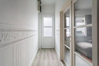 Deze gezellige starterwoning bevindt zich op een centrale en goed bereikbare locatie, met winkels, scholen en openbaar vervoer in de nabije omgeving. Je woont hier rustig, maar toch met alle voorzieningen binnen handbereik — ideaal voor wie comfort en bereikbaarheid belangrijk vindt.<br /><br />Bij het binnenkomen word je ontvangen in de inkomhal, van waaruit je via een deur de sfeervolle zitkamer binnenstapt. Deze ruimte is afgewerkt met een mooie parketvloer en geniet dankzij de grote ramen van veel natuurlijke lichtinval, wat meteen zorgt voor een warme en uitnodigende sfeer. De zitkamer loopt door naar de eetkamer, die eveneens baadt in het daglicht. Deze lichtrijke ruimte vormt het centrale punt van de woning en biedt voldoende plaats voor een eettafel. Hier bevindt zich ook de trap naar de bovenverdieping, wat zorgt voor een vlotte en logische circulatie.<br />Aansluitend kom je in de keuken, die praktisch is ingericht en uitgerust met een oven en veel kastruimte. Deze ruimte is voorzien van een tegelvloer, net als de achterliggende badkamer. De badkamer beschikt over zowel een bad als een aparte douche en is afgewerkt met een lavabo en lavabomeubel. Het aparte toilet, eveneens met deur, biedt extra privacy en comfort.<br /><br />Op de bovenverdieping bevinden zich twee volwaardige slaapkamers, allebei afgewerkt met parket en ruim genoeg voor een dubbel bed, kasten en eventueel een bureau. De warme vloerafwerking en het praktische formaat maken deze kamers veelzijdig inzetbaar — ideaal als master bedroom, kinderkamer, hobbyruimte of thuiskantoor.<br /><br />Hoewel het EPC van 337 (label D) ruimte laat voor verbetering, biedt dit pand veel potentieel voor wie graag zelf moderniseert en de woning verder wil afwerken naar eigen smaak. Dankzij de charmante uitstraling, de logische indeling, de mooie lichtinval en het gezellige karakter vormt dit huisje een ideale starterswoning voor singles of koppels.