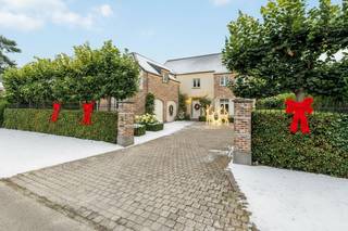 Prachtige villa met 6 slaapkamers op een mooi perceel van 1.329 m². Op het gelijkvloers ruime leefruimte met eetkamer, salon, ingerichte keuken met ontbijthoek, wasplaats en dubbele inpandige garage. Op de eerste verdieping bevinden zich 3 slaapkamers, badkamer, dressing en apart toilet en via een aparte trap nog een logeerkamer met ensuite douchekamer. Op de zolderverdieping bevinden zich nog 2 extra slaapkamers en de CV-ruimte.<br /><br />Mooie, diepe tuin met prachtig zonneterras, siervijver en tuinhuis.<br /><br />Indeling gelijkvloers:<br />Via de ruime inkomhal met gastentoilet heeft u onmiddellijk toegang het woongedeelte. Deze is zeer ruim opgevat en bestaat uit een lichte eetkamer met prachtig zicht over de tuin en een gezellige zitkamer met inbouwcassaette (op gas). Vanuit alle leefruimten heeft u een prachtig zicht op de aangelegde tuin met siervijver achteraan.<br />Aansluitend aan de eetkamer bereiken we de luxe leefkeuken voorzien van een gaskookplaat (6 pits), heteluchtoven, microgolfoven, stoomoven, vaatwasser en Amerikaanse koelkast (overname in overleg). <br />Tevens is er een ruime en praktische bijkeuken/wasplaats en een dubbele inpandige garage.<br />Eerste verdieping:<br />Via een aparte trap in de bijkeuken komt u in een aparte logeerkamer met aansluitend douchekamer (douche, wastafel en toilet) boven de garage.<br />Via de trap in de inkomhal komt u op de 1ste verdieping en hier biedt de nachthal toegang tot 3 slaapkamers op deze verdieping. Deze zijn allen voorzien van op maat gemaakte kasten en de hoofdslaapkamer is voorzien van een ruime dressing. Verder is er nog een apart toilet en een volledig ingerichte badkamer (dubbele wastafel, douche en ligbad). <br />Tweede verdieping:<br />Via een vaste trap komen we tot dit volwaardige extra verdiep. Hier treffen we de Cv-ruimte en nog 2 extra slaapkamers, waarvan één voorzien van op maat gemaakte kasten.<br /><br />BIJZONDERHEDEN<br />- Alarmsysteem<br />- 20 zonnepanelen + batterij<br />- CV op aardgas<br />- Grondwaterput aanwezig (voor automatische beregening van de tuin – 5circuits)<br />- Zuidgerichte tuin