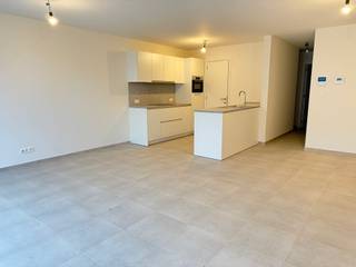 <p>Dit energiezuinig nieuwbouwappartement met 2 slaapkamers en een groot zuidgericht terras biedt een uitzonderlijke woonervaring voor wie op zoek is naar comfort, kwaliteit en duurzaamheid. Gelegen in een aangename en goed bereikbare omgeving, vormt dit appartement de perfecte balans tussen rustig wonen en praktische nabijheid van voorzieningen.</p><p>Bij het betreden van het appartement kom je in een inkomhal die toegang geeft tot de verschillende ruimtes. De lichtrijke leefruimte met open keuken vormt het hart van de woning en geniet van grote raampartijen die zorgen voor een overvloed aan natuurlijk licht. Vanuit de leefruimte heb je directe toegang tot het ruime zuidgerichte terras, waar je de hele dag door kan genieten van zon en buitenleven.</p><p>De open keuken wordt volledig geïntegreerd in de leefruimte en biedt alle mogelijkheden om een moderne en functionele keuken naar eigen wens in te richten. Aansluitend bevindt zich een praktische berging/wasplaats die extra opbergruimte en comfort biedt in het dagelijkse gebruik.</p><p>Het appartement beschikt over twee volwaardige slaapkamers, ideaal voor een gezin, koppel of als combinatie van wonen en thuiswerken. De douchekamer is stijlvol en functioneel ingericht en er is bovendien een apart toilet aanwezig, wat het wooncomfort verhoogt.</p><p>Een bijzonder sterke troef van dit nieuwbouwappartement is de mogelijkheid om de volledige afwerking nog vrij te kiezen. Dit laat toe om materialen, kleuren en afwerkingsgraad volledig af te stemmen op jouw persoonlijke smaak en woonwensen. Er wordt gewerkt met kwalitatieve en duurzame materialen die garant staan voor een hoogwaardige afwerking.</p><p>Op technisch vlak is het appartement uitgerust met de nieuwste energiezuinige technieken. Dankzij geothermie en zonnepanelen geniet je van een lage energiefactuur en een toekomstgerichte investering. De vloerverwarming zorgt voor een aangename en gelijkmatige warmteverdeling in alle ruimtes en draagt bij aan het algemene wooncomfort.</p><p>Bovendien kan dit appartement, onder bepaalde voorwaarden, aangekocht worden aan het verlaagde btw-tarief van 6%, wat een aanzienlijke financiële meerwaarde kan betekenen.</p><p>Dit appartement is ideaal voor wie op zoek is naar een instapklare, duurzame en kwalitatieve woonoplossing met een hoog niveau van personalisatie. Zowel voor eigen bewoning als investering vormt dit een bijzonder interessante opportuniteit.</p>